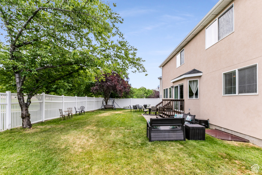 Fenced backyard featuring an outdoor hangout area