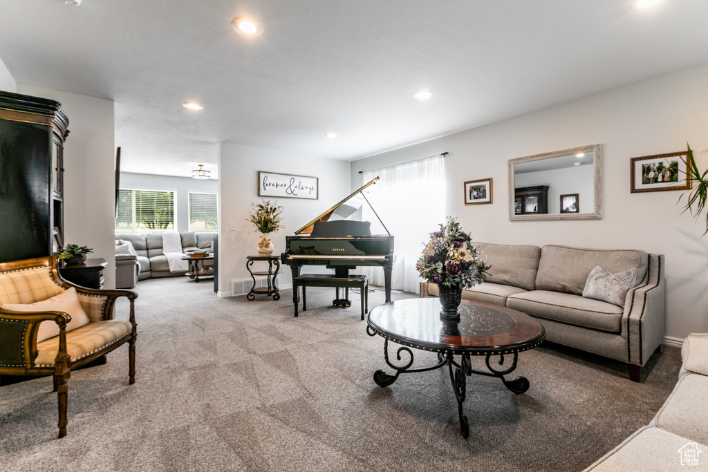 Carpeted living area featuring recessed lighting