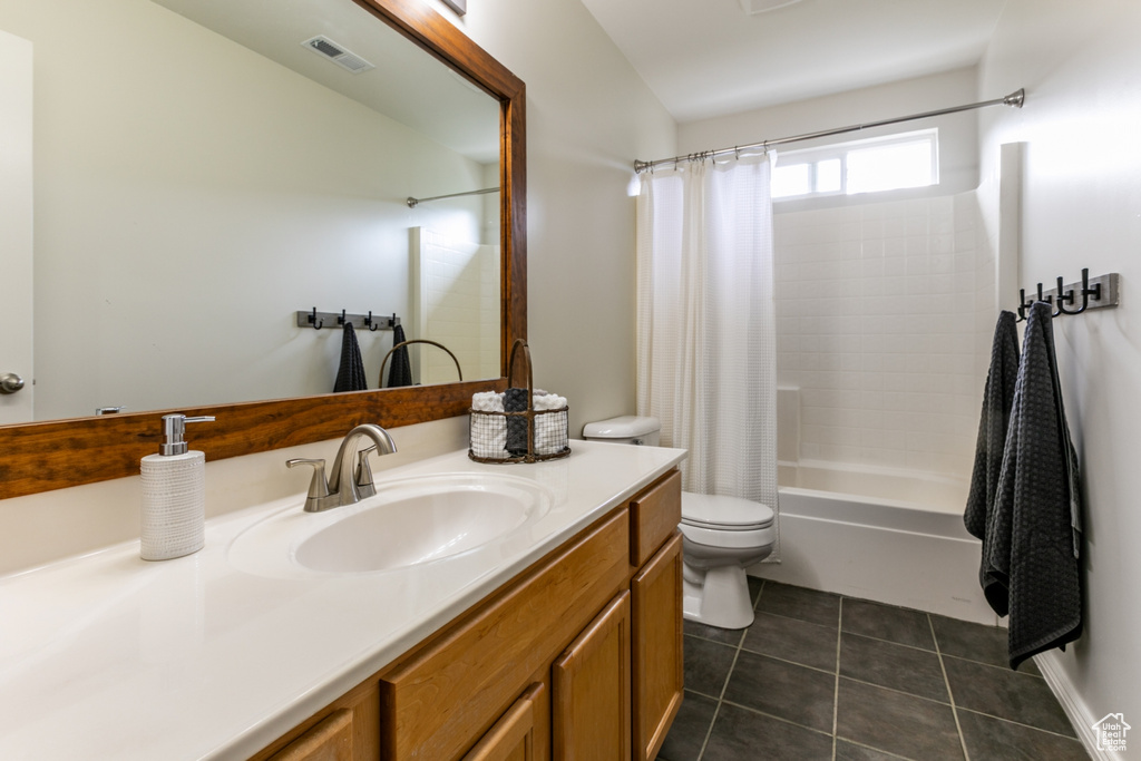 Full bath featuring vanity, shower / tub combo, and tile patterned floors