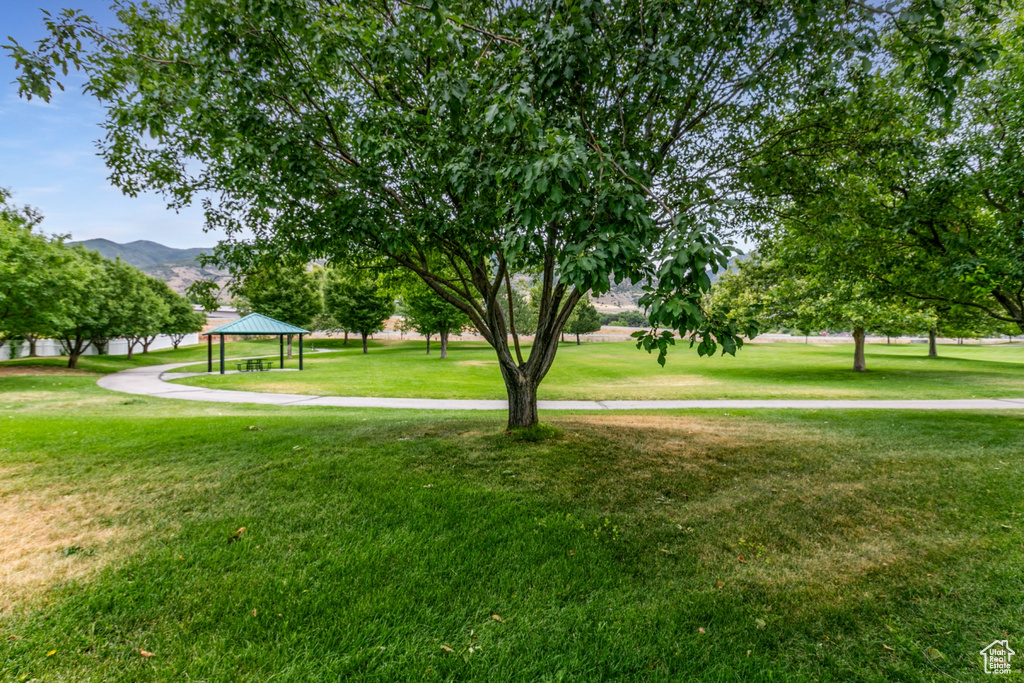 View of property's community with a gazebo, a lawn, and a mountain view