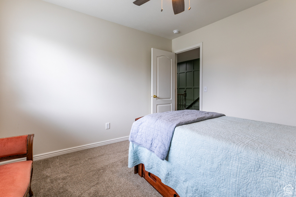Carpeted bedroom with baseboards and ceiling fan