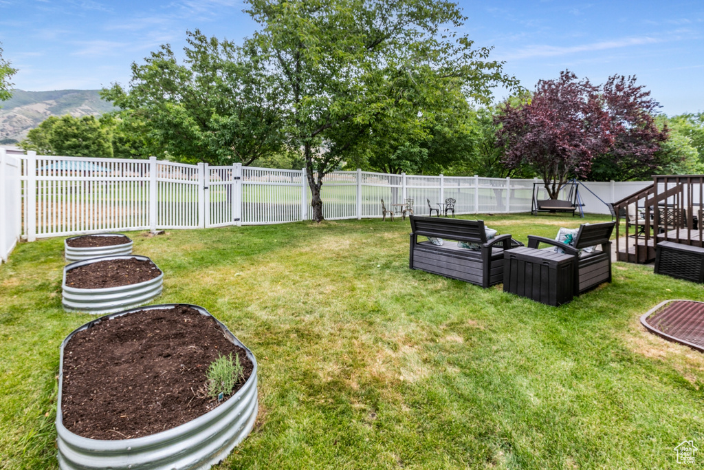 Fenced backyard with an outdoor living space and a mountain view