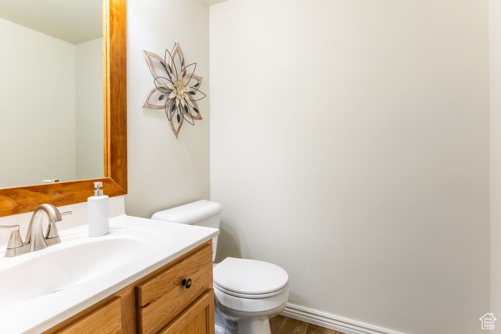 Bathroom with wood finished floors and vanity