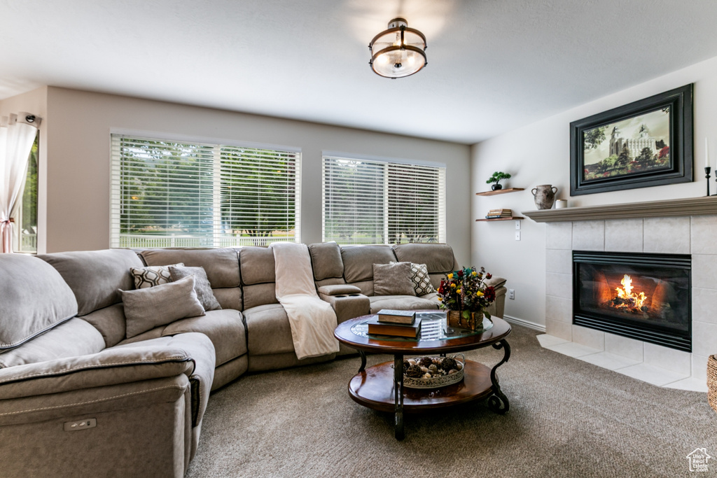 Carpeted living area featuring a fireplace