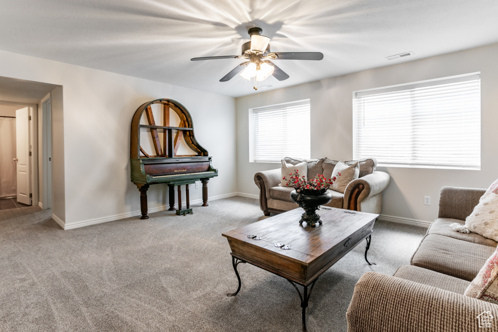 Living room featuring ceiling fan and light colored carpet