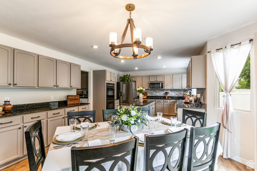 Dining space with a chandelier, recessed lighting, and light wood finished floors