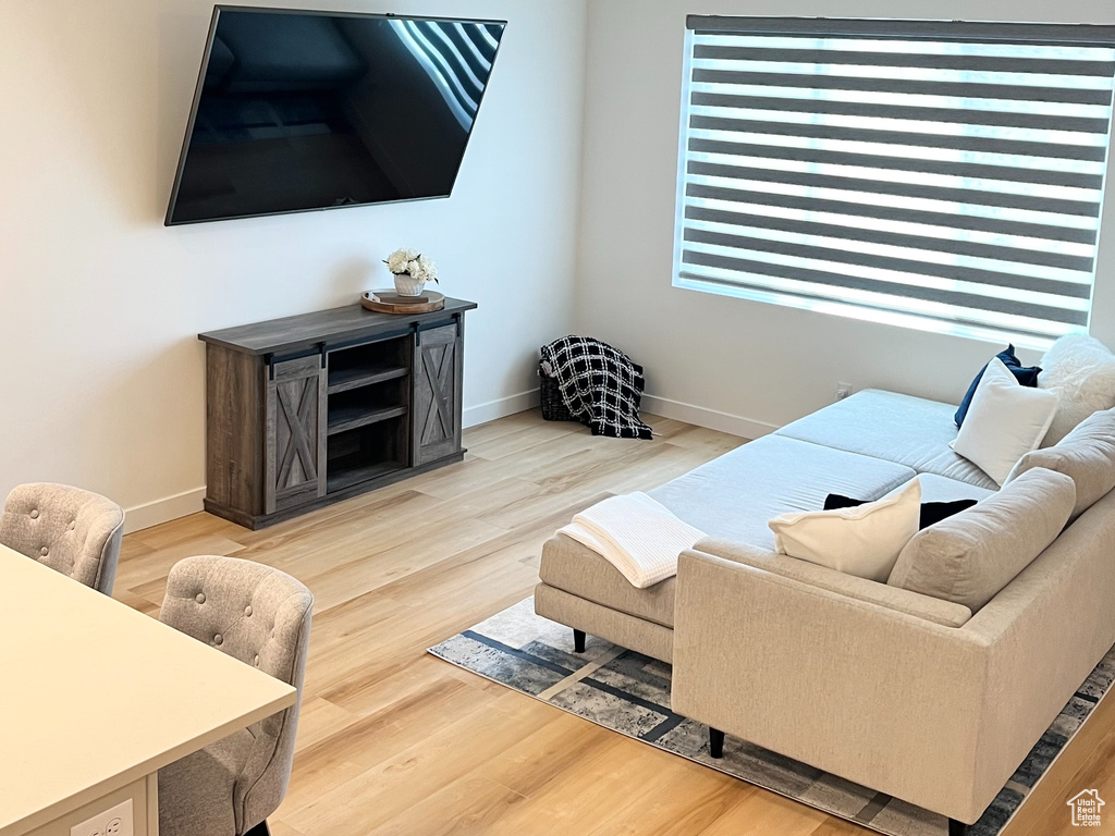 Living room featuring a textured ceiling and light wood-style flooring