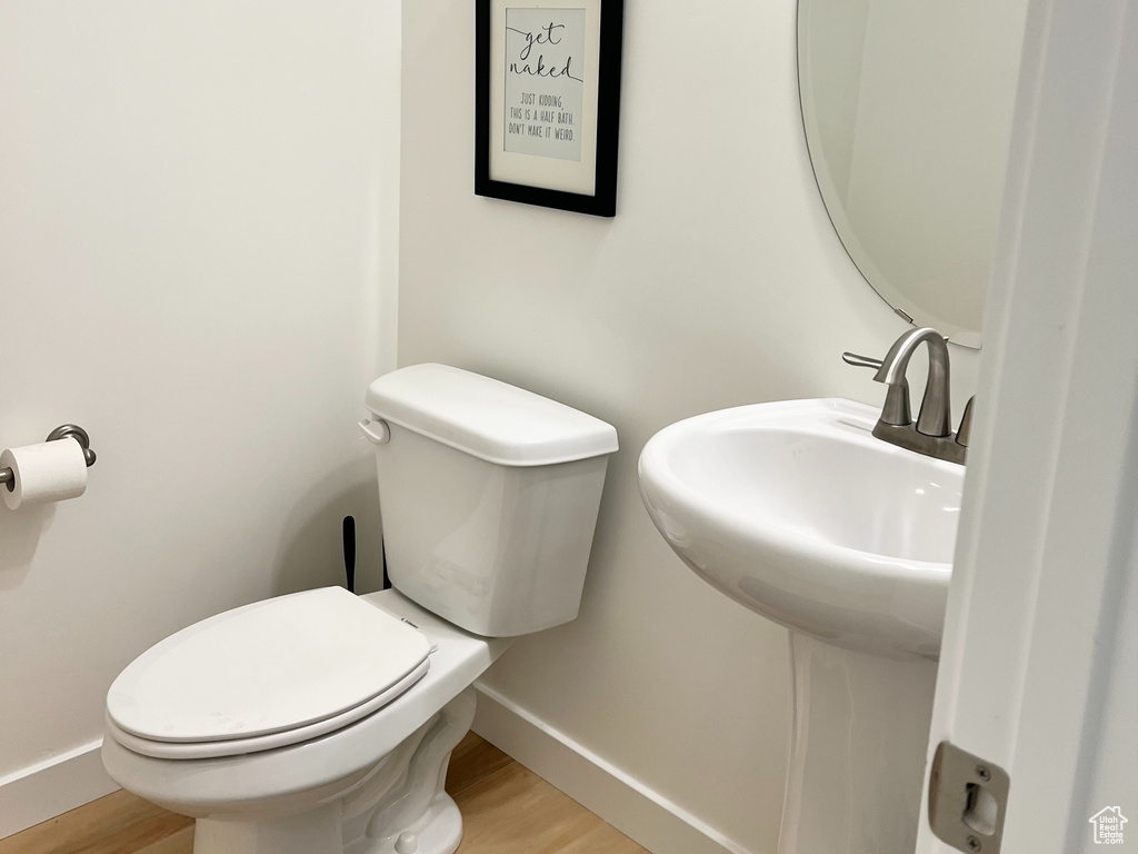 Bathroom featuring toilet and wood finished floors