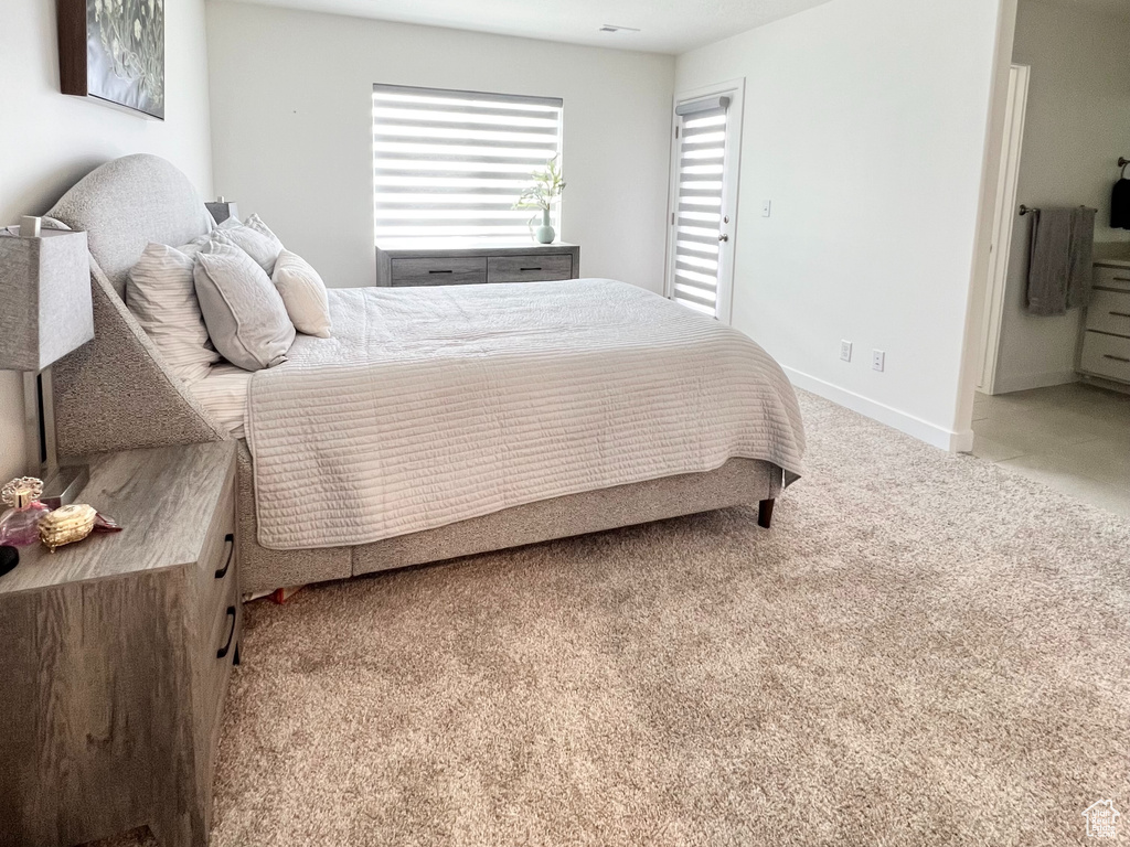 Bedroom featuring light colored carpet and a textured ceiling