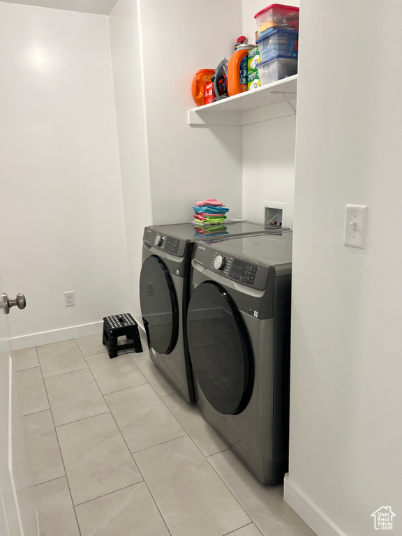 Laundry room featuring independent washer and dryer and light tile patterned floors