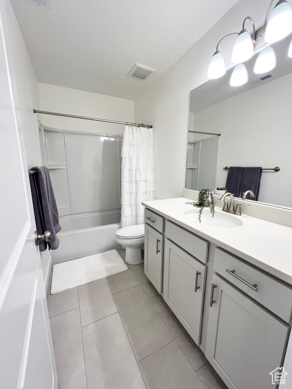Bathroom featuring vanity, shower / tub combo with curtain, and tile patterned floors