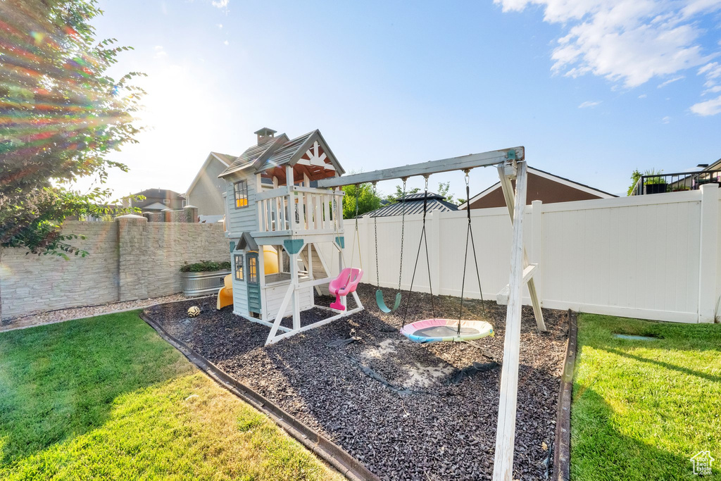 View of play area featuring a fenced backyard