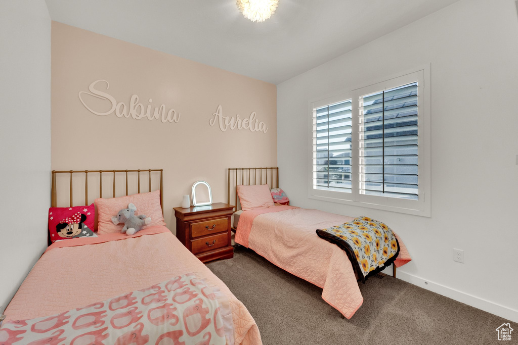 Carpeted bedroom featuring baseboards