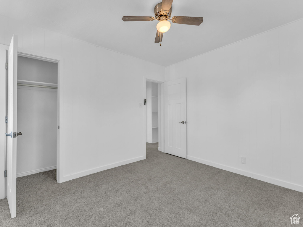 Unfurnished bedroom featuring carpet flooring, a ceiling fan, and a closet