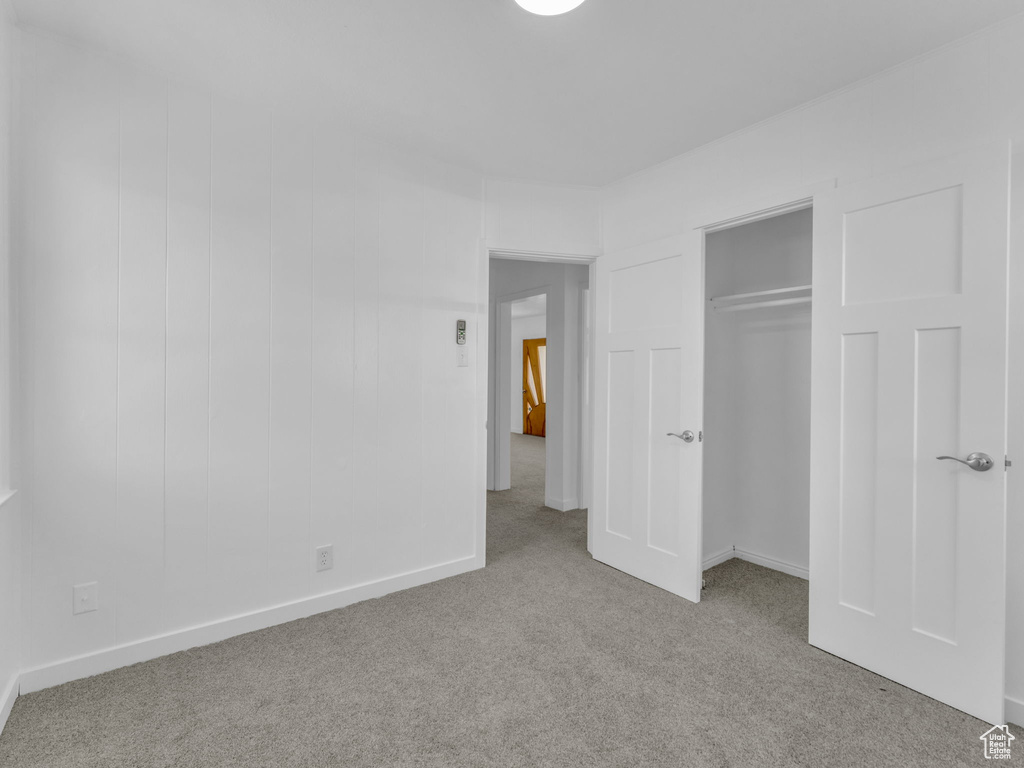 Unfurnished bedroom featuring carpet floors and a closet
