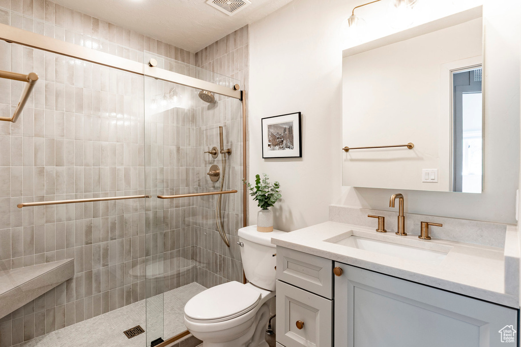Full bath with vanity and a stall shower