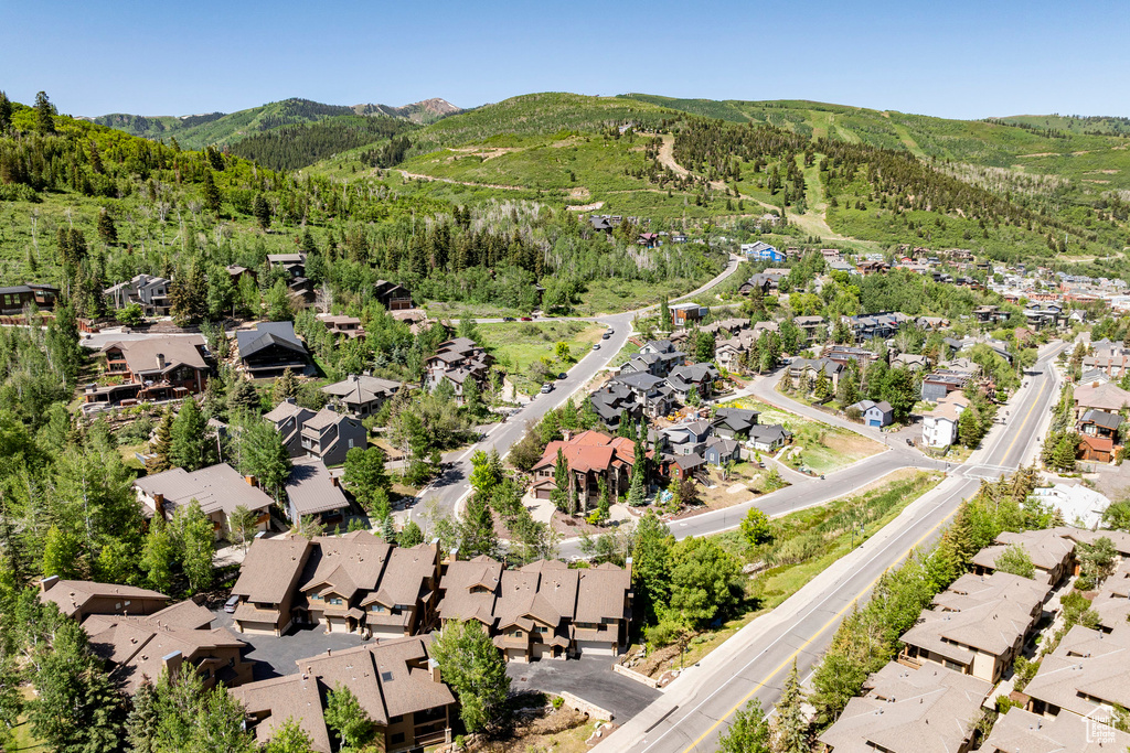 Aerial overview of property's location with mountains and nearby suburban area