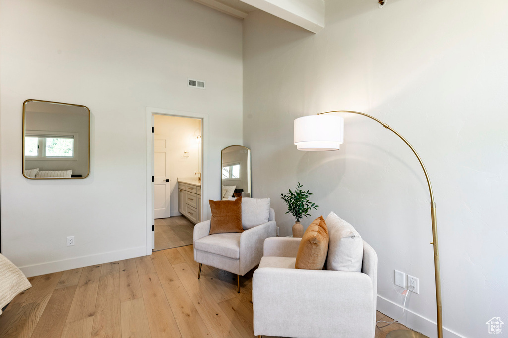 Living area featuring a high ceiling and light wood-type flooring
