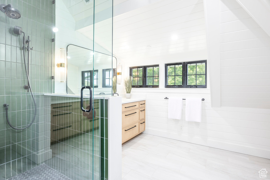 Full bath featuring a stall shower and vanity