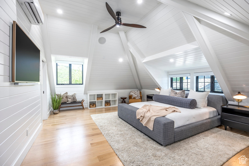 Bedroom featuring a wall unit AC, multiple windows, light wood-style floors, and recessed lighting