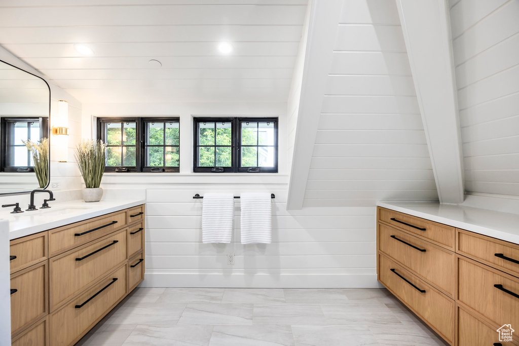 Bathroom featuring vanity and marble finish flooring