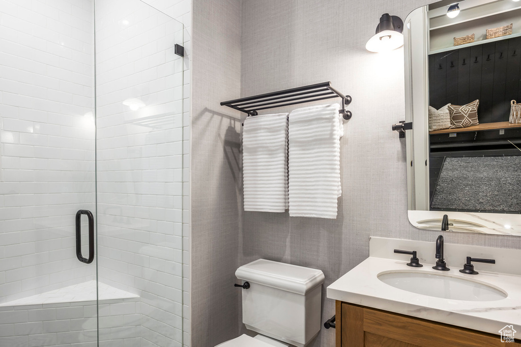 Bathroom featuring vanity and a shower stall