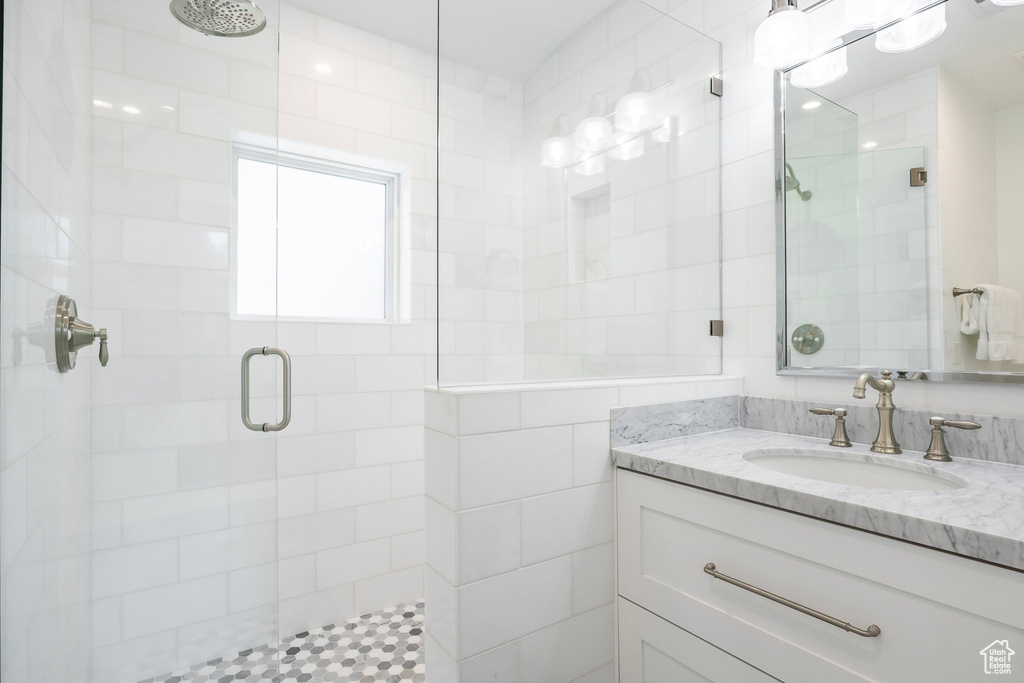 Full bath with a stall shower and vanity