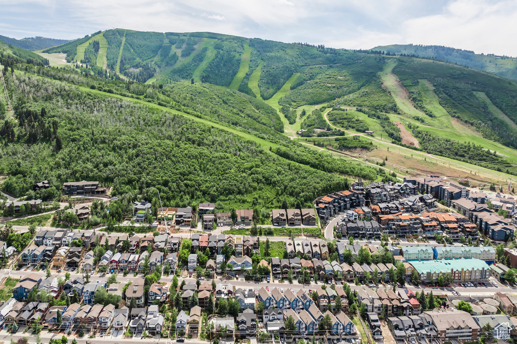Aerial view of property's location with mountains and nearby suburban area