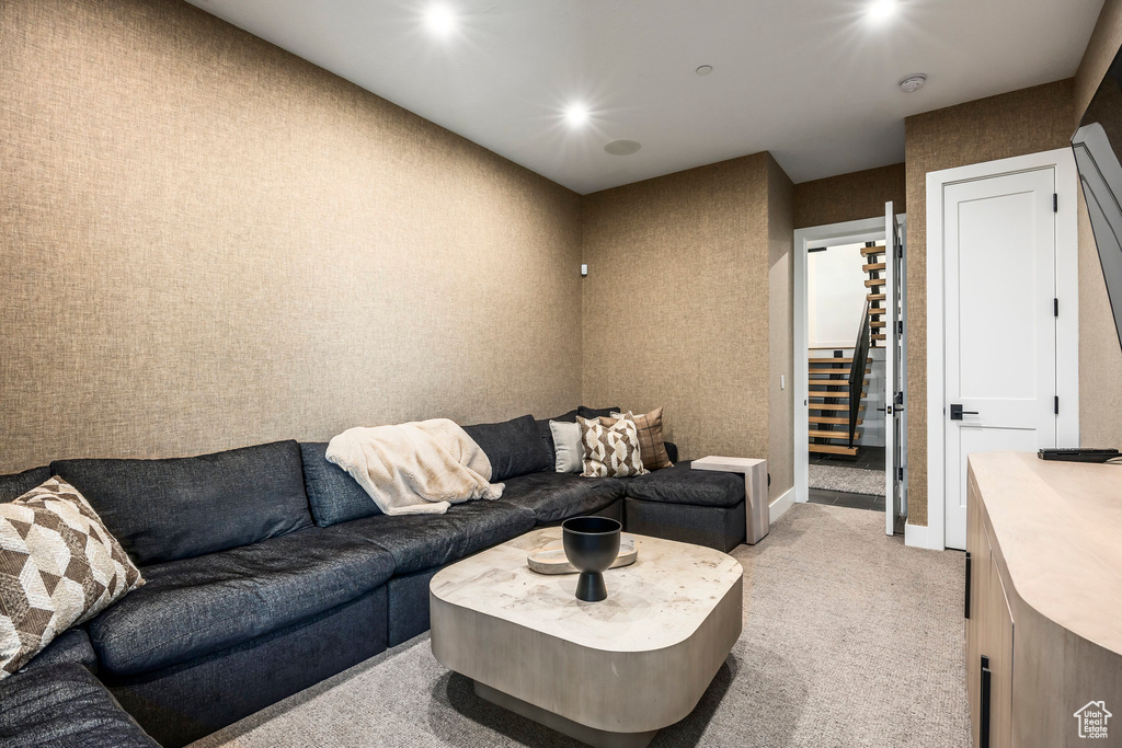 Living area with light carpet and baseboards