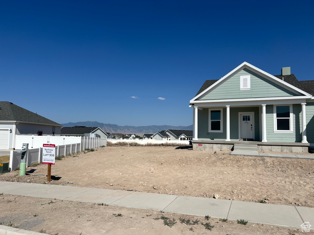 View of front of property featuring a mountain view and covered porch