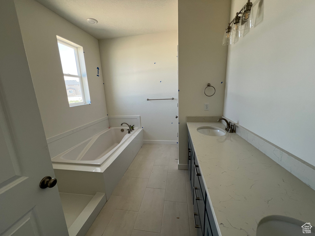 Full bath featuring vanity and a bath