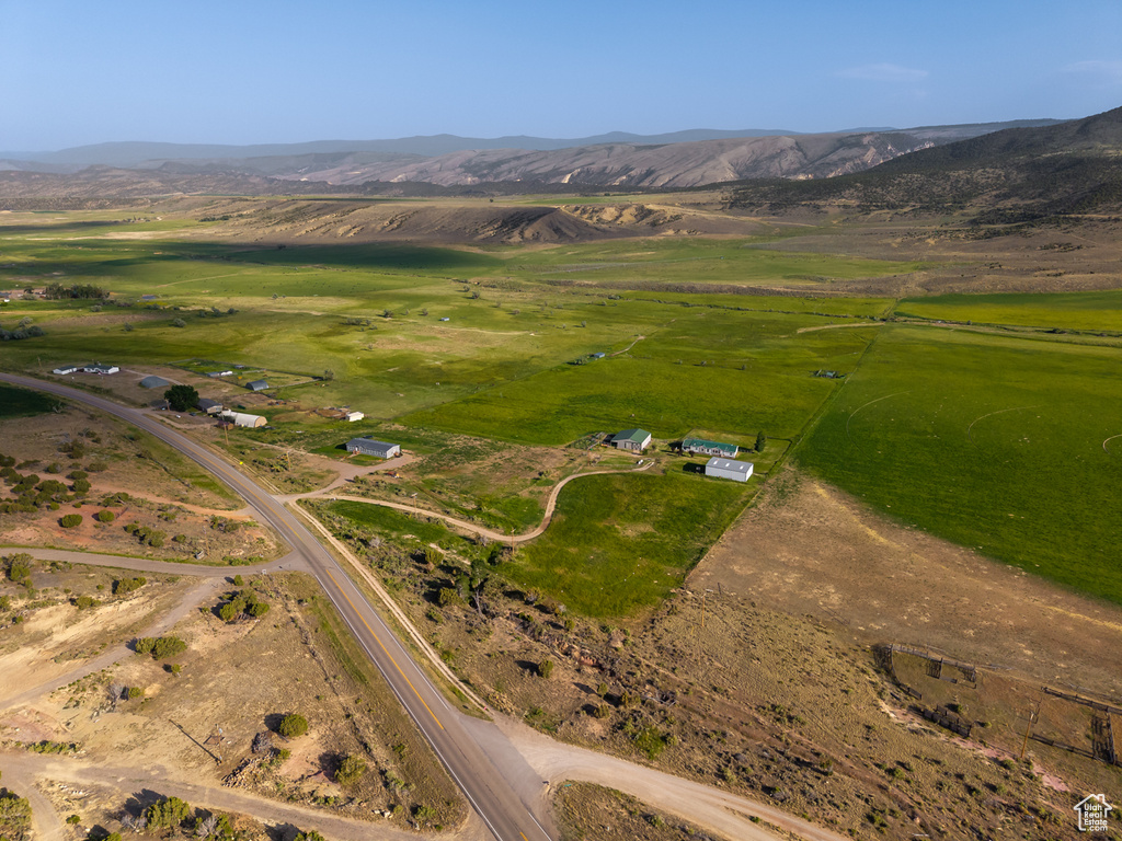 Aerial view of property's location with a mountainous background and rural landscape
