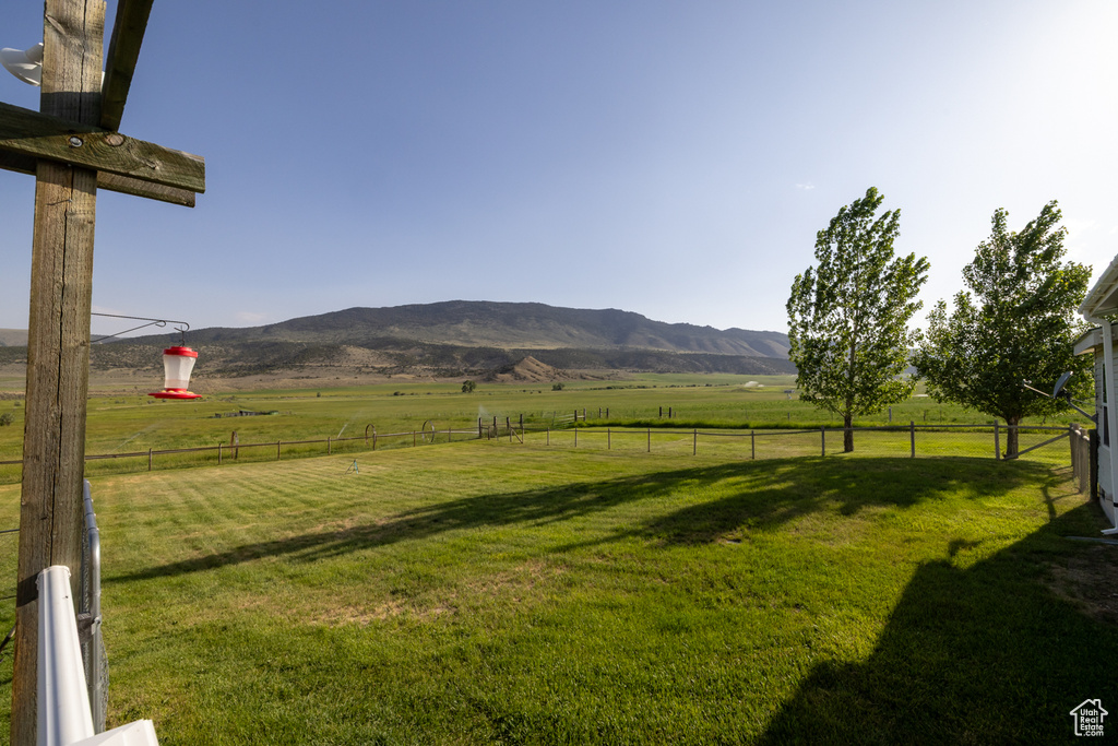 View of yard featuring a rural view and a mountain view
