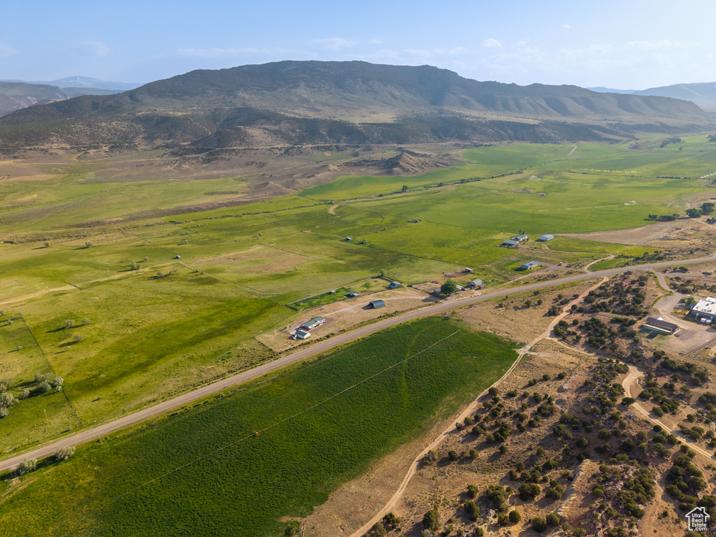 Aerial overview of property's location featuring rural landscape and a mountainous background