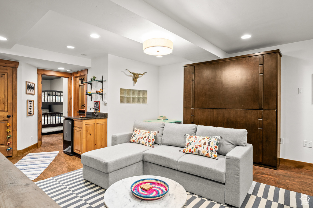 Living area with recessed lighting and light wood-style flooring
