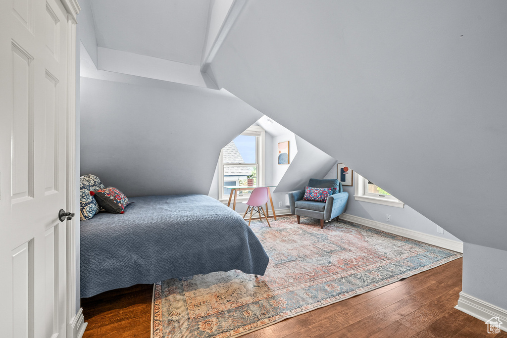 Bedroom featuring multiple windows and wood finished floors