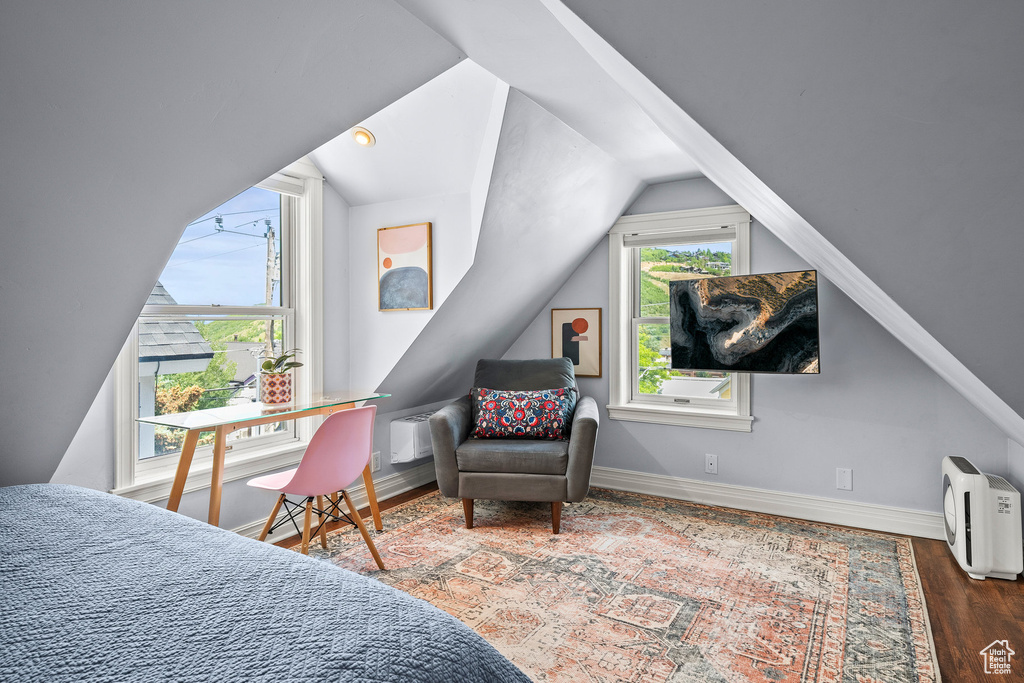 Bedroom featuring vaulted ceiling and wood finished floors
