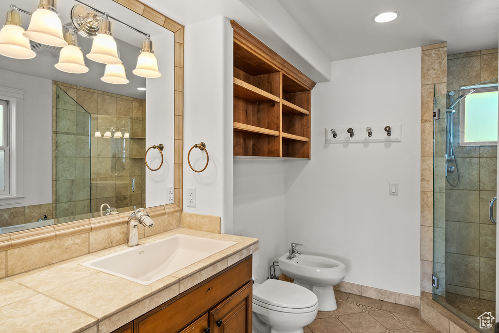 Bathroom with a bidet, vanity, a stall shower, tile patterned floors, and recessed lighting