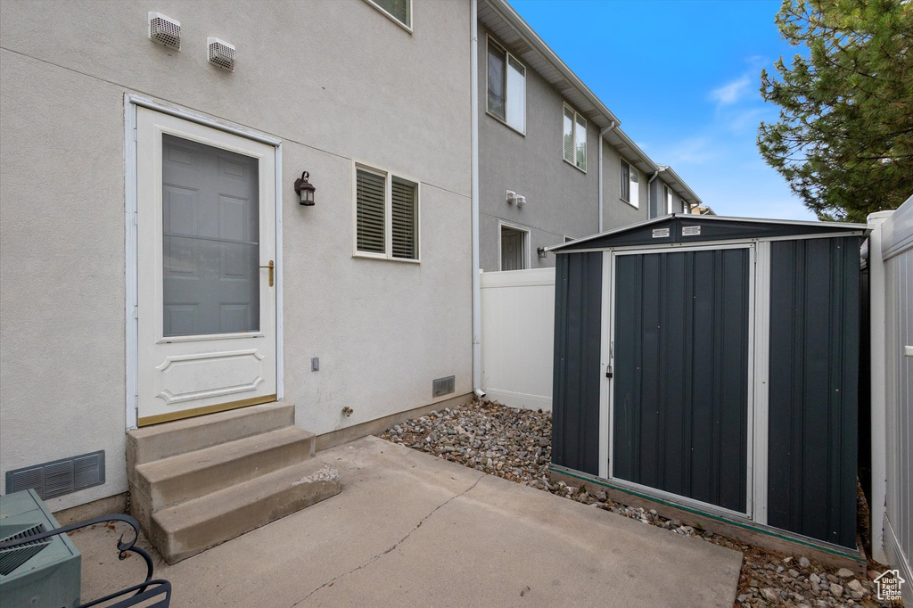 View of exterior entry featuring a patio area and stucco siding