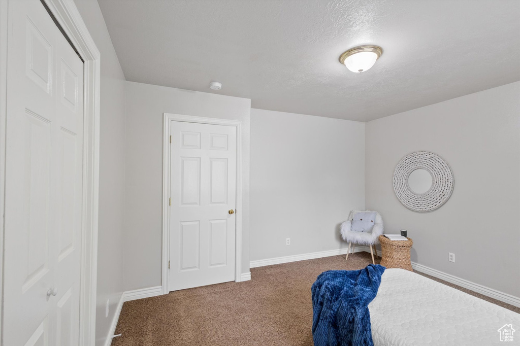 Carpeted bedroom featuring baseboards