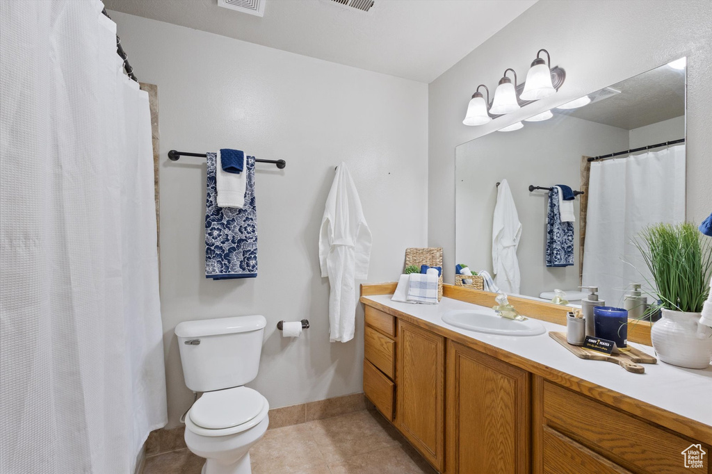 Full bath featuring vanity, tile patterned flooring, and a shower with curtain