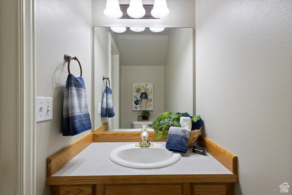 Bathroom featuring vanity and a textured wall