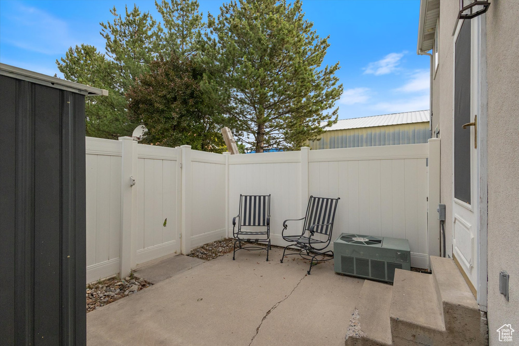 Fenced backyard with a patio and a gate