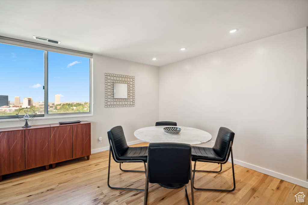 Dining room featuring light wood-style flooring and recessed lighting