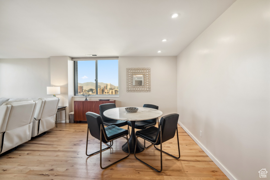 Dining space featuring recessed lighting and light wood-style flooring