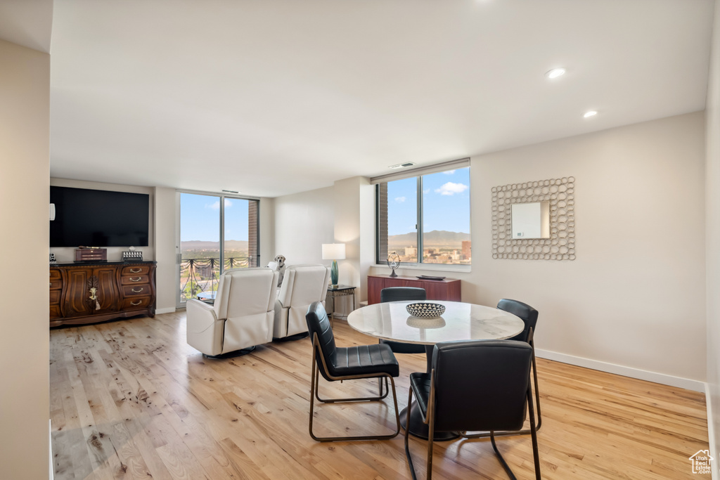 Dining space with wood finished floors and recessed lighting