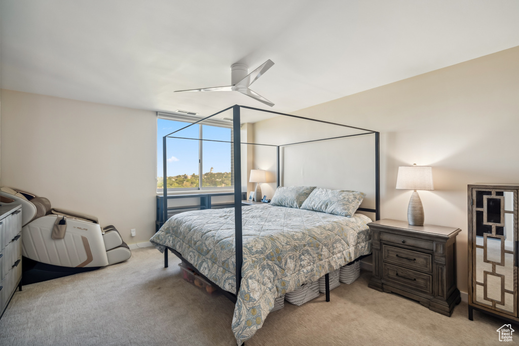 Bedroom featuring light carpet and a ceiling fan