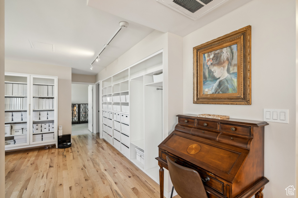 Hallway featuring light wood-style flooring