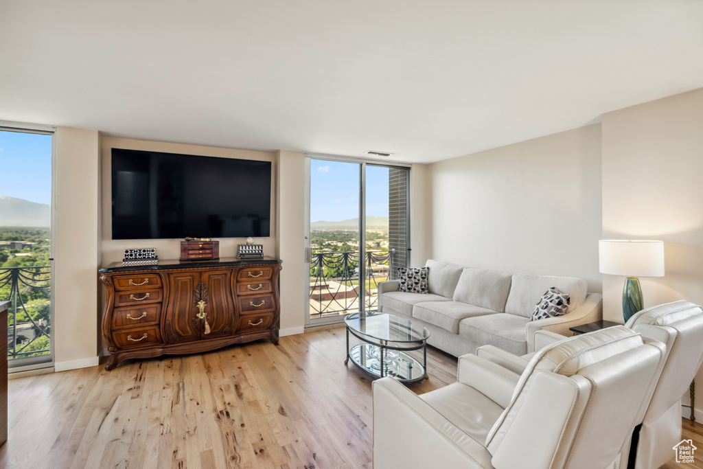 Living area with expansive windows and light wood-style floors