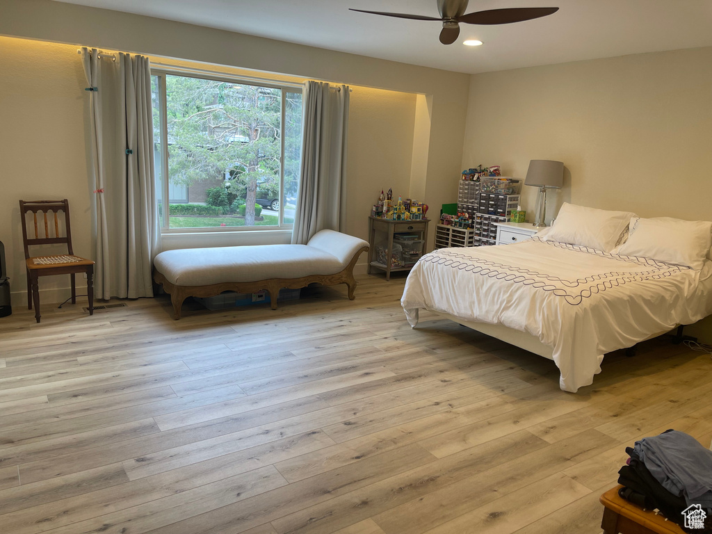 Bedroom with light wood finished floors, recessed lighting, and a ceiling fan